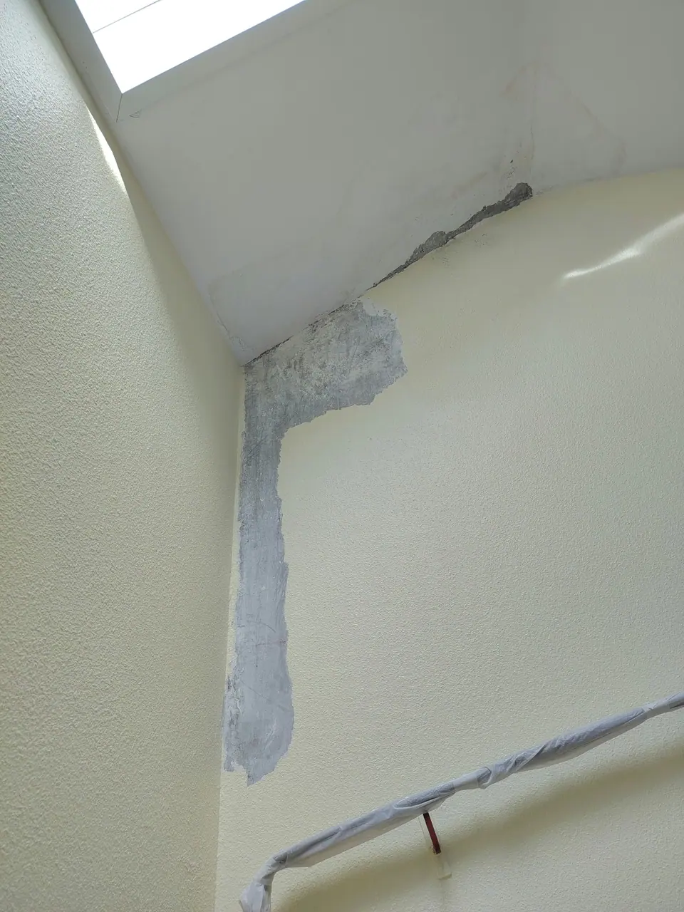 Avant travaux : enduit qui se détache dans une cage d'escalier